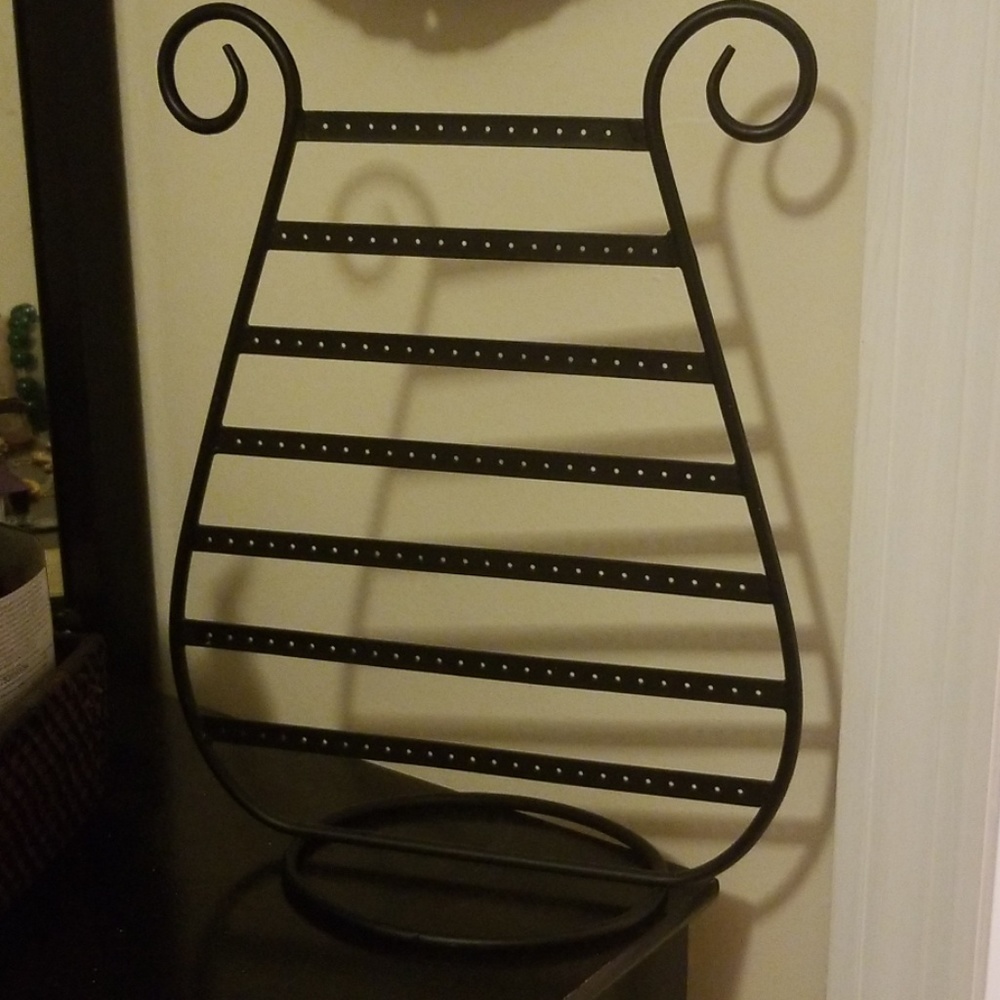 Earring holder. Harp shaped. Black metal.